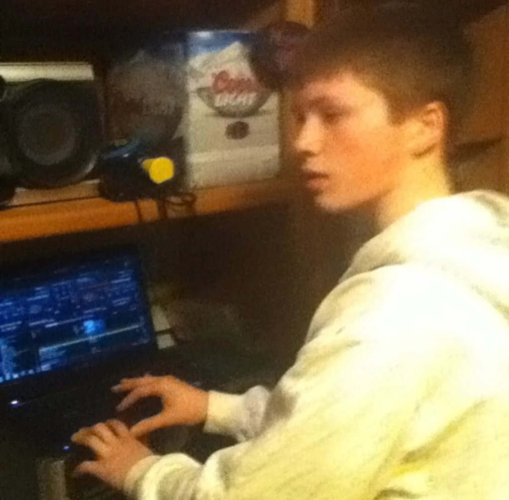 A young Jason Kushy producing music on a laptop